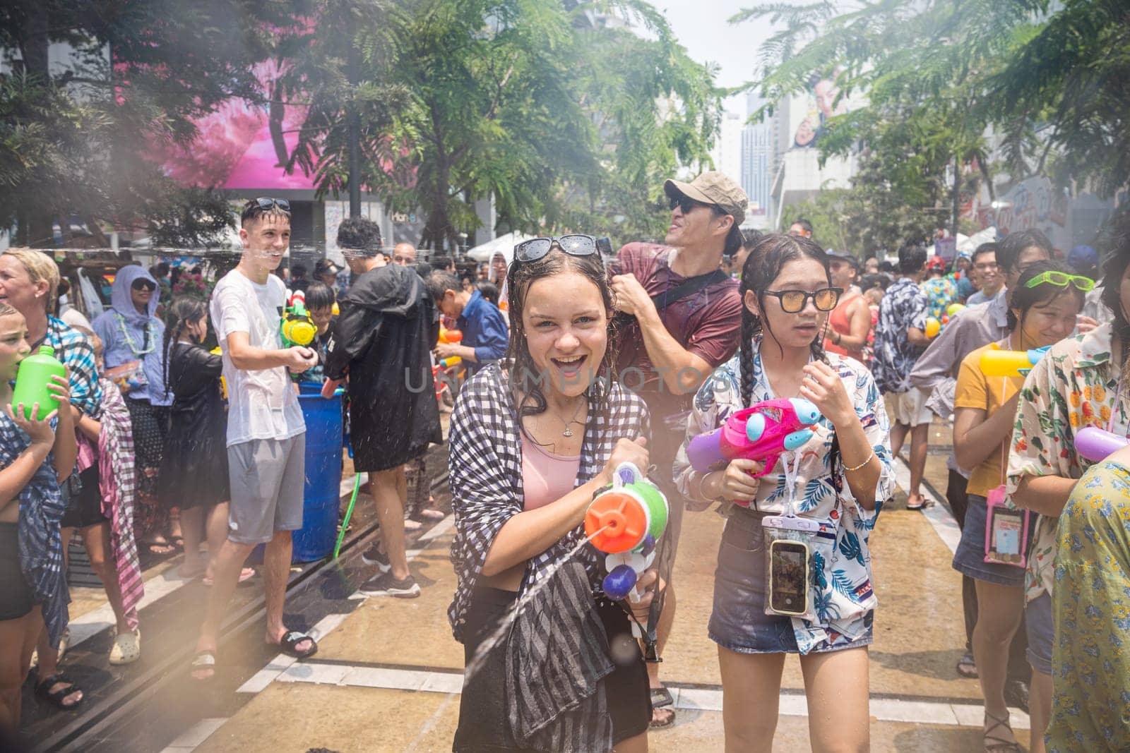 Siam Square, Bangkok, Thailand - APR 13, 2023 Songkran Festival, The short action of people joins celebrations of the Thai New Year or Songkran in Siam Square Bangkok, Thailand.