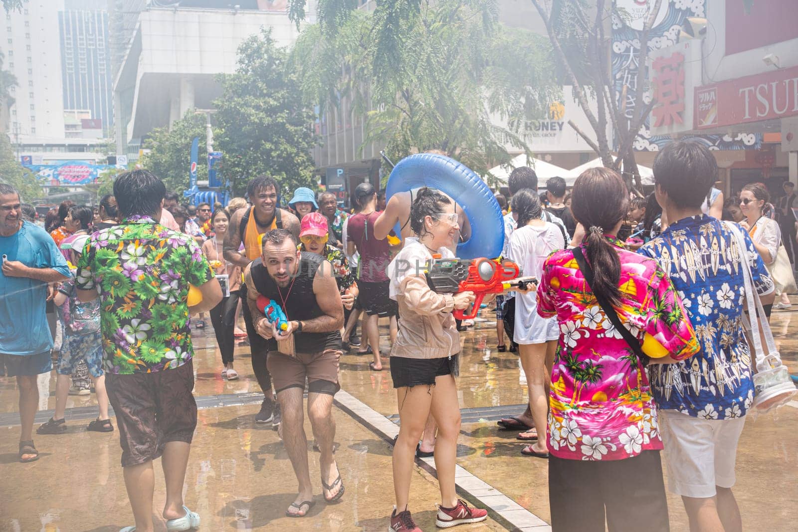 Siam Square, Bangkok, Thailand - APR 13, 2023 Songkran Festival, The short action of people joins celebrations of the Thai New Year or Songkran in Siam Square Bangkok, Thailand.