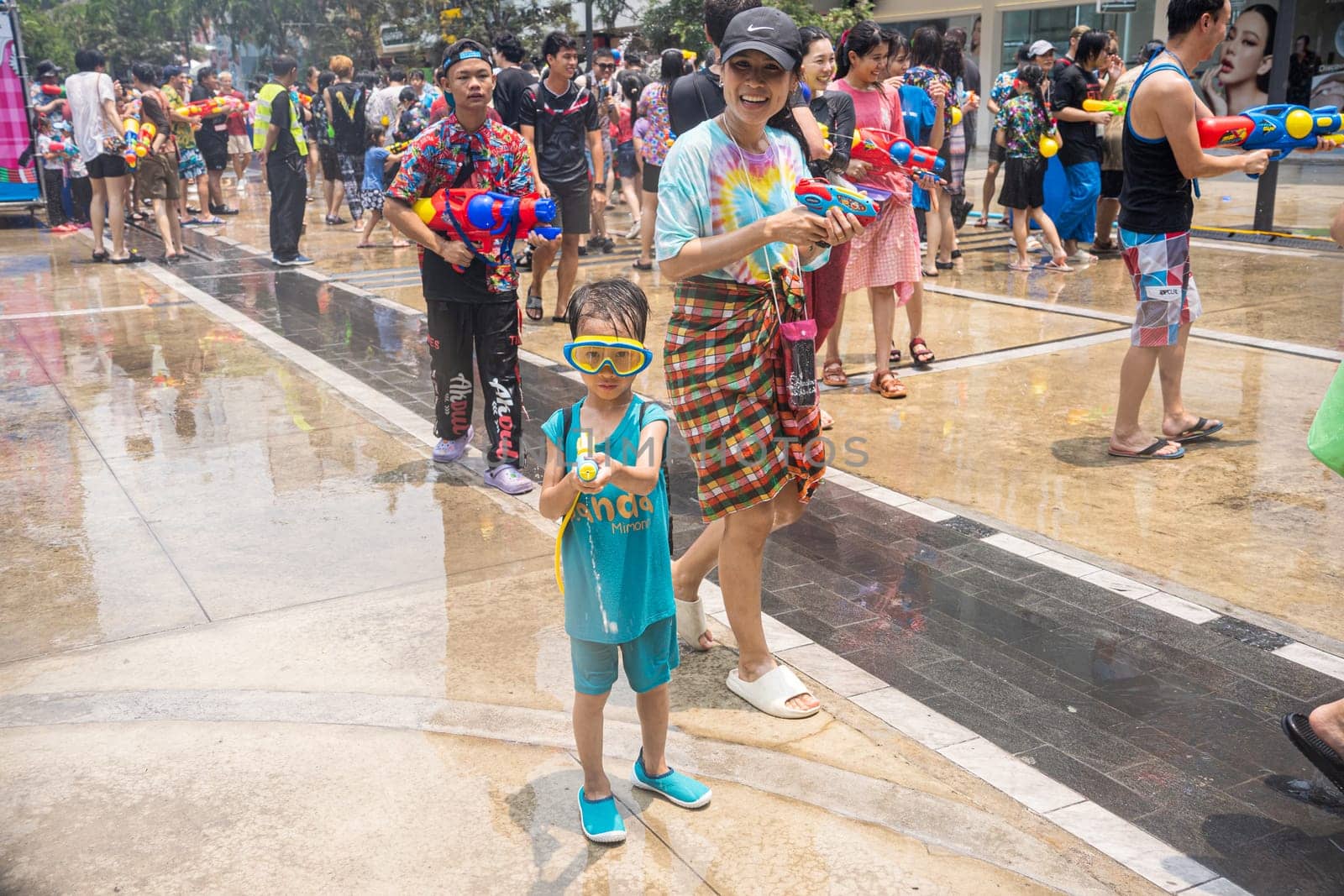 Siam Square, Bangkok, Thailand - APR 13, 2023 Songkran Festival, The short action of people joins celebrations of the Thai New Year or Songkran in Siam Square Bangkok, Thailand.