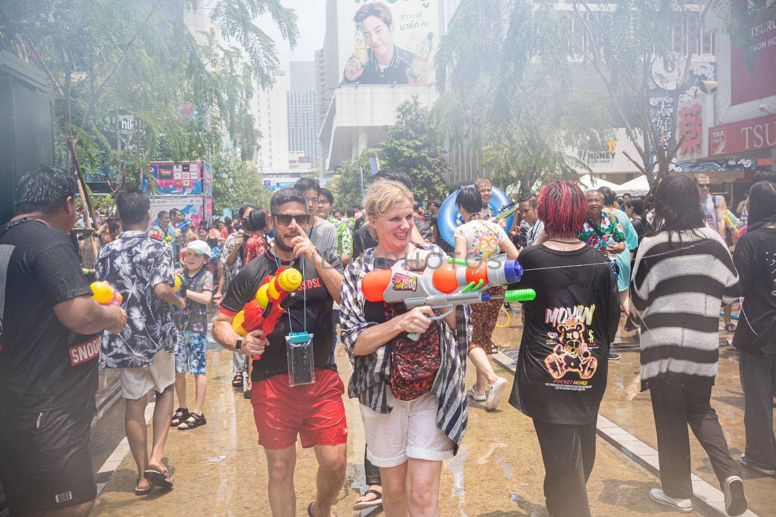 Siam Square, Bangkok, Thailand - APR 13, 2023 Songkran Festival, The short action of people joins celebrations of the Thai New Year or Songkran in Siam Square Bangkok, Thailand.