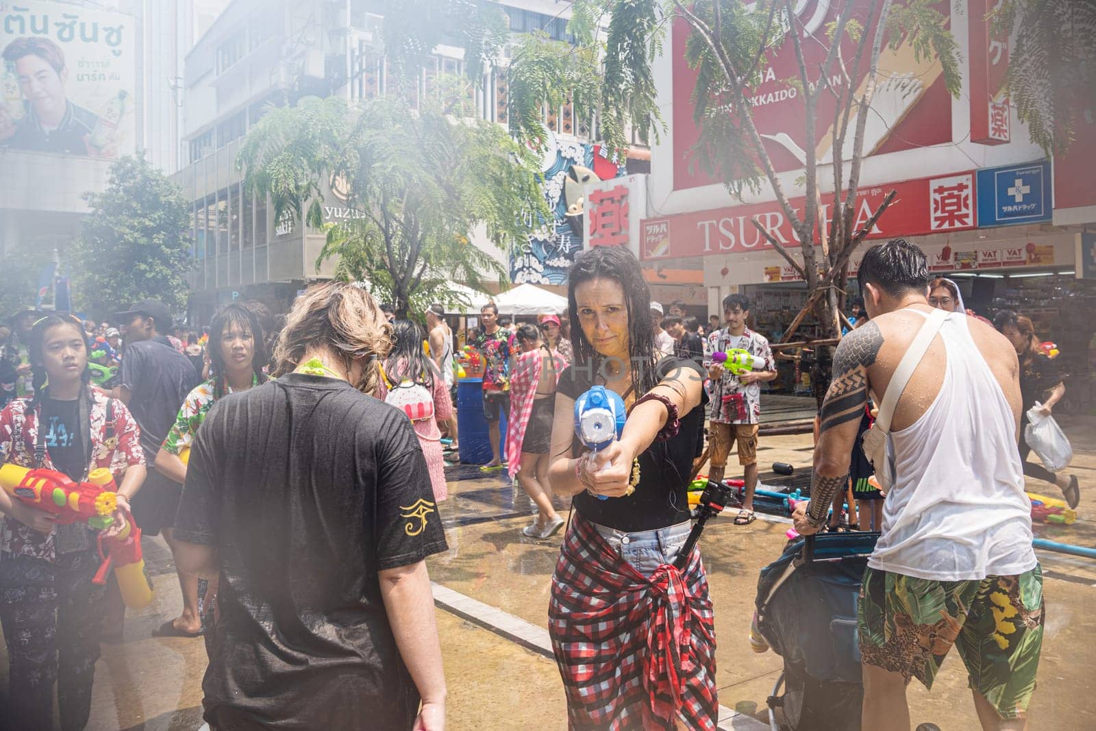 Siam Square, Bangkok, Thailand - APR 13, 2023 Songkran Festival, The short action of people joins celebrations of the Thai New Year or Songkran in Siam Square Bangkok, Thailand.