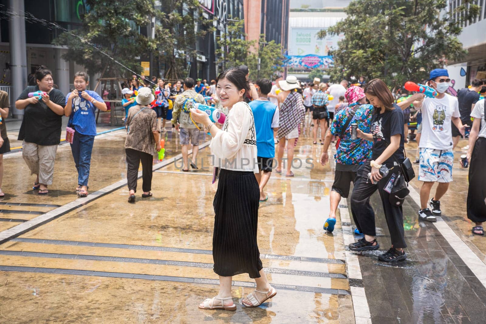 Siam Square, Bangkok, Thailand - APR 13, 2023 Songkran Festival, The short action of people joins celebrations of the Thai New Year or Songkran in Siam Square Bangkok, Thailand.