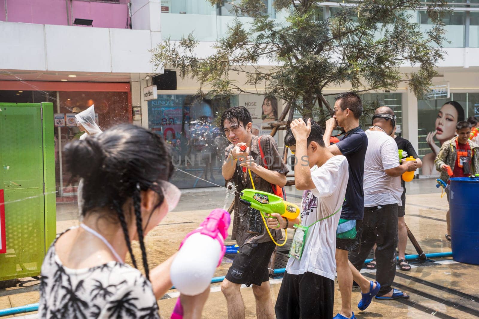 Siam Square, Bangkok, Thailand - APR 13, 2023 Songkran Festival, The short action of people joins celebrations of the Thai New Year or Songkran in Siam Square Bangkok, Thailand.