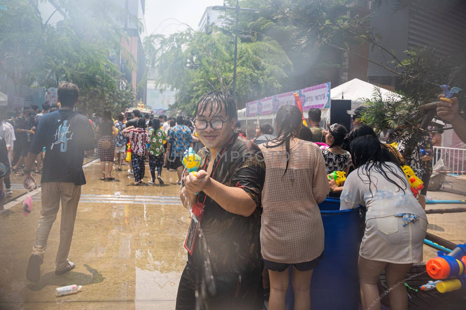 Siam Square, Bangkok, Thailand - APR 13, 2023 Songkran Festival, The short action of people joins celebrations of the Thai New Year or Songkran in Siam Square Bangkok, Thailand.