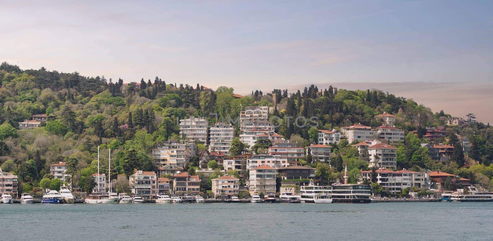 Istanbul, Turkey - May 8, 2023: Stunning view of the Bebek neighborhood, with its traditional colorful buildings perched on a hill overlooking the Bosphorus Strait
