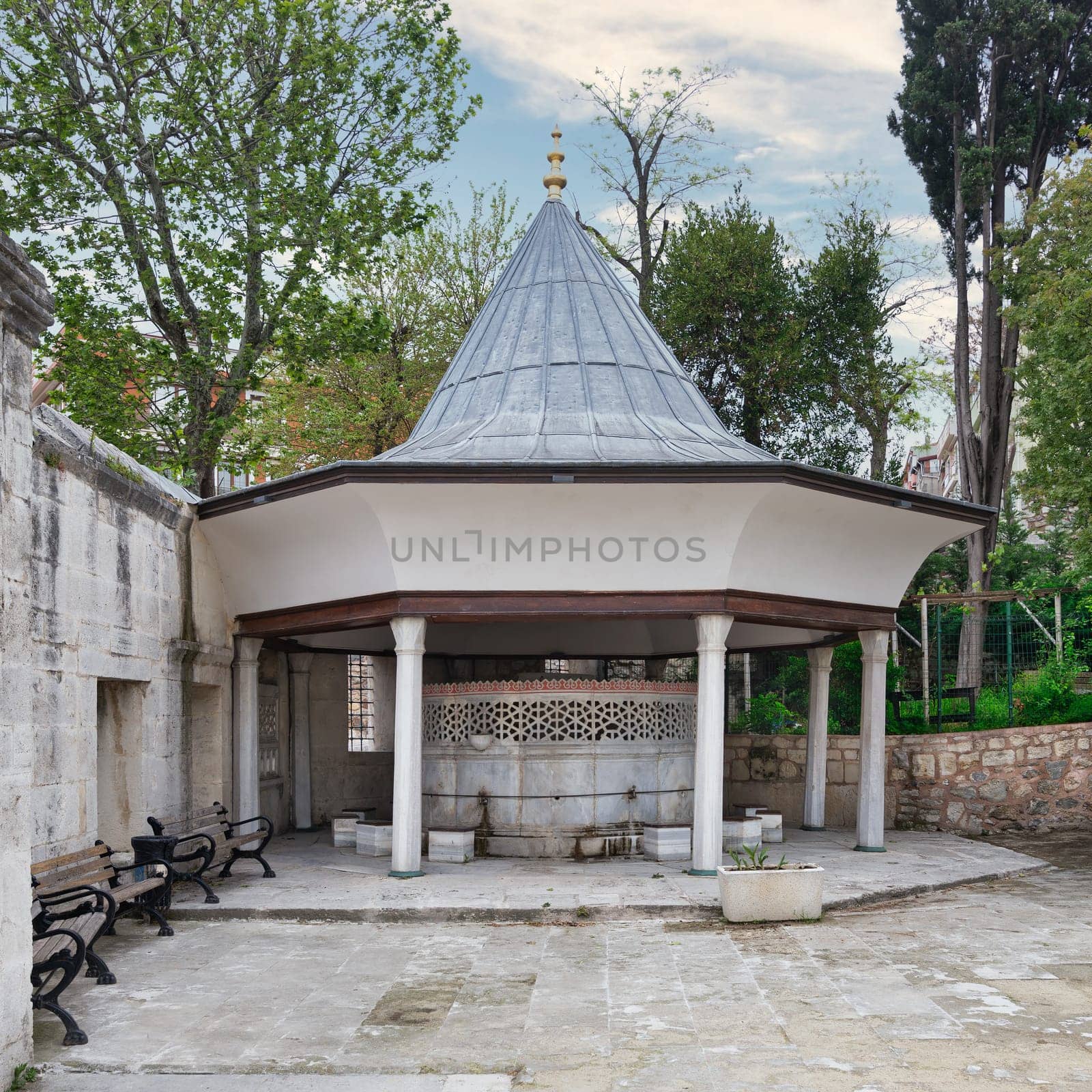 Ablution fountain in the courtyard of 17th century Ottoman era Cinili Mosque, Uskudar district, Istanbul, Turkey. The fountain is made of white marble and has a beautiful geometric design