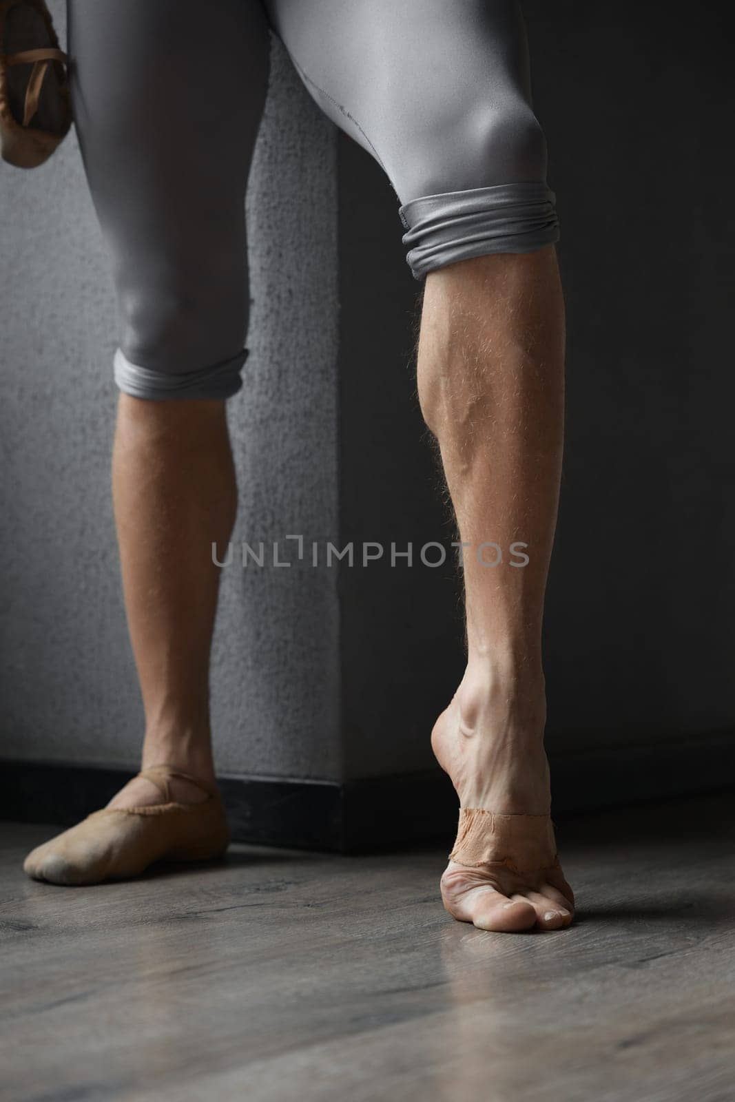 Strong trained legs of male ballet dancer cropped shot. Hard work and training for dance movement perfection