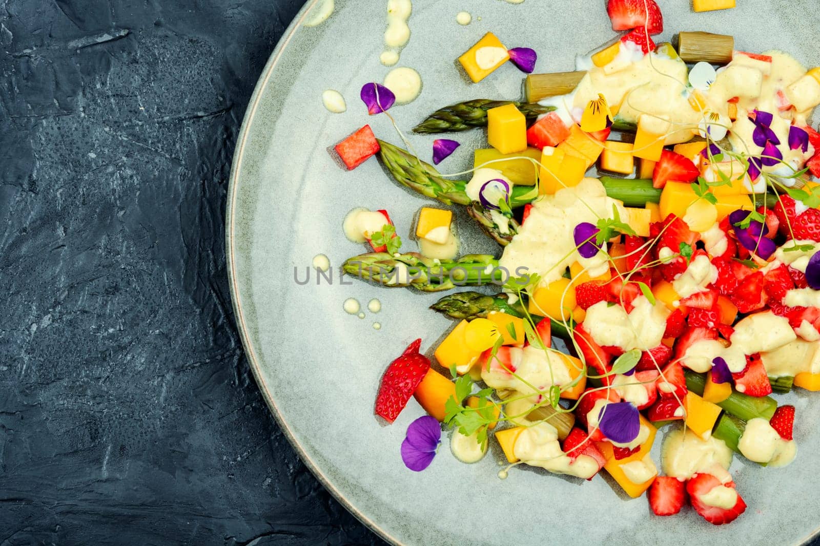 Summer salad with spice, strawberries, yogurt and ripe mango. Healthy balanced eating. Copy space.