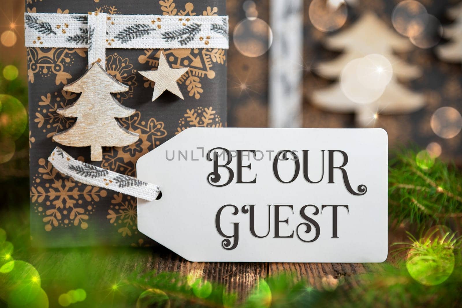 Text Be Our Guest, On A White Label With Christmas Presents, Winter Gifts, Natural, Eco Friendly Background