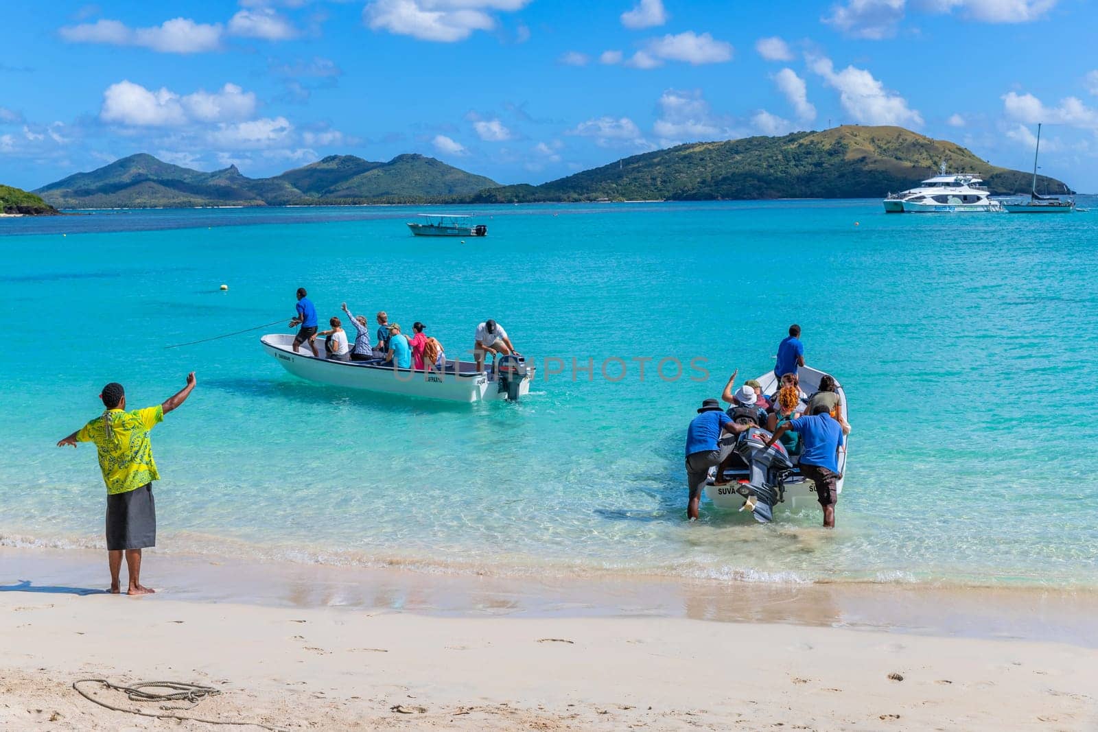 Nacula, Fiji: 26 May 2023: Tourists at the tropical sandy beach of Nacula island, Yasawa islands, Fiji, South Pacific Islands, Pacific