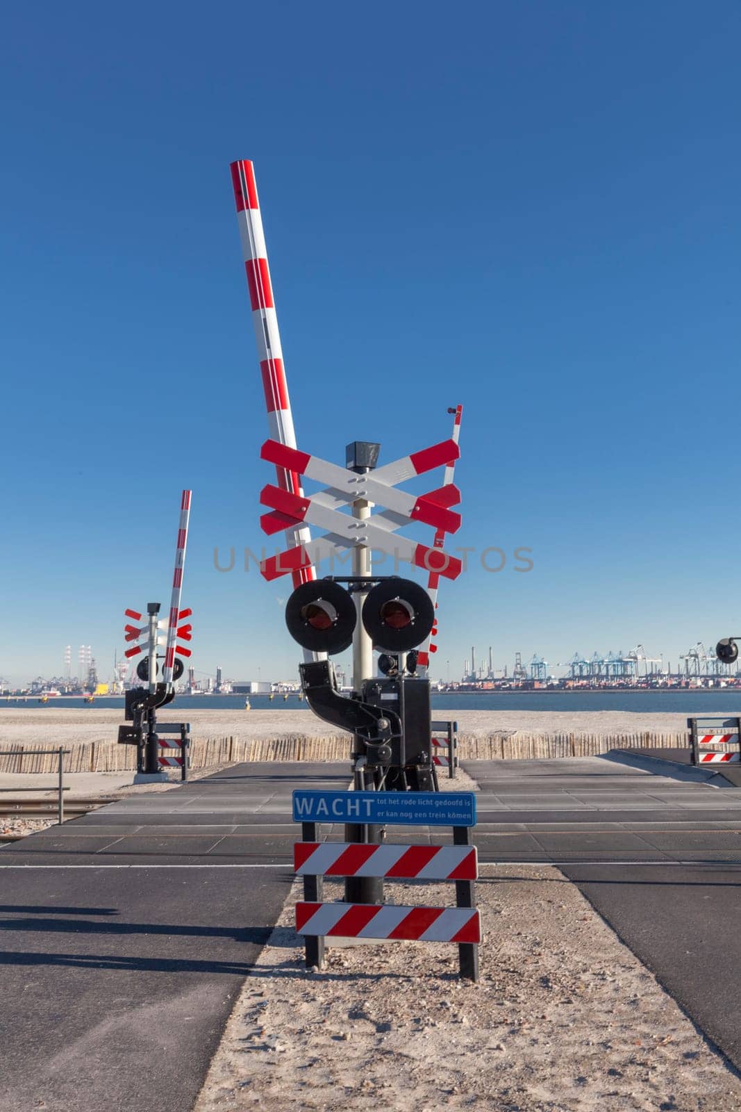 Road signs at the railway crossing with a barrier. Organization of the transport system of a European country. Safety of traffic in road and rail transport, Rotterdam