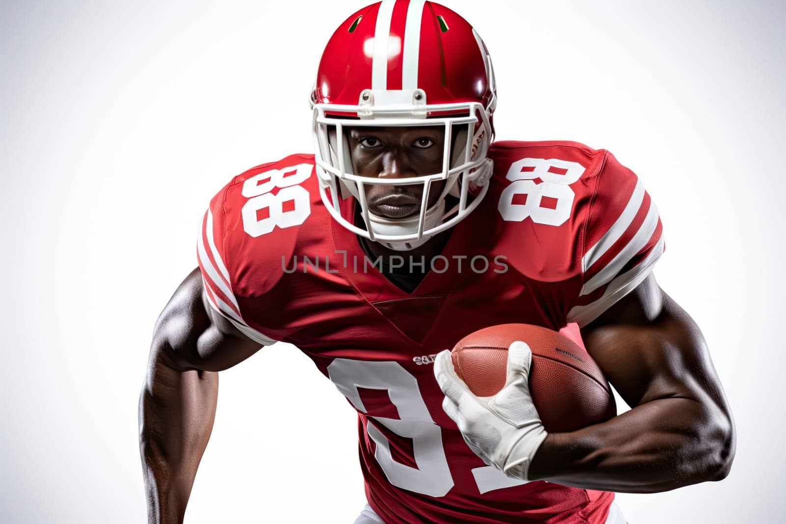 Portrait of American football player in red jersey holding ball against white background.