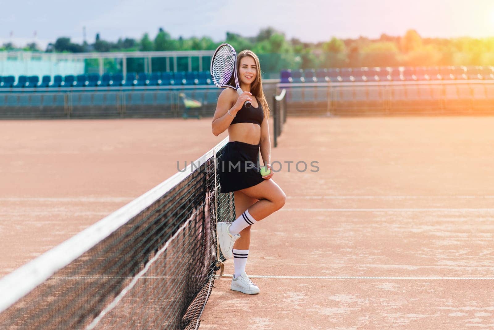 Sports Fashion. Beautiful Woman On Tennis Court. Portrait Of Stylish Sexy Girl In Black Trendy Sportswear Holding Tennis Racket On Outdoor Court. High Resolution.