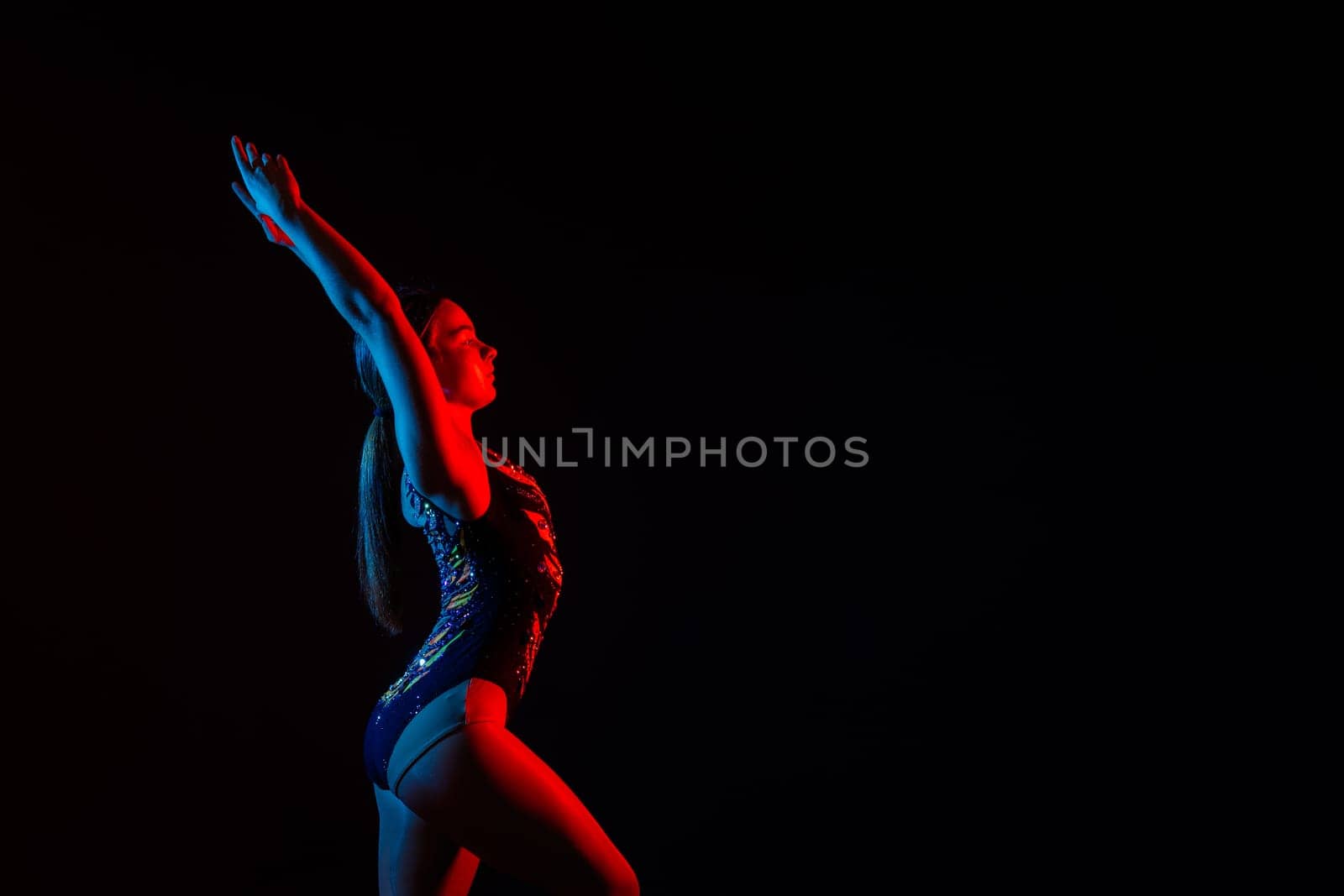 Fashion girl ballet dancer. Sport gymnastics studio shot on a white and black background