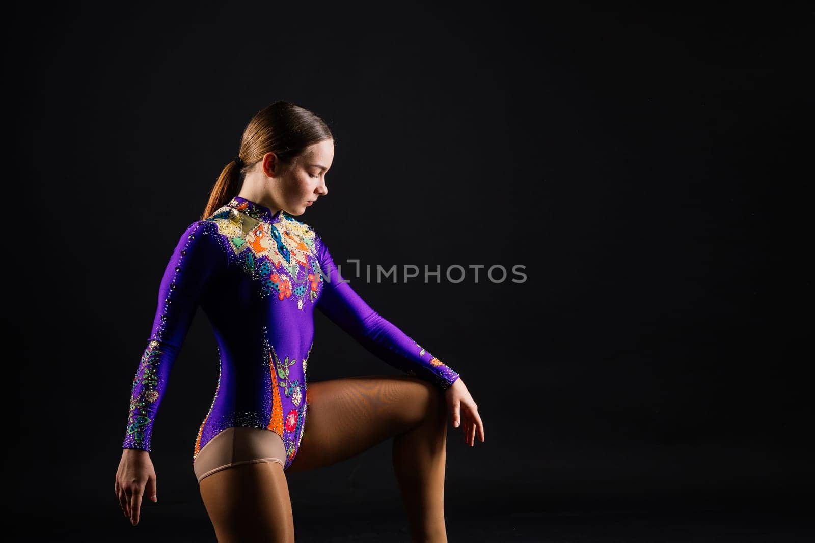Portrait of a beautiful young woman gymnast training calilisthenics exercise with acrobatic element