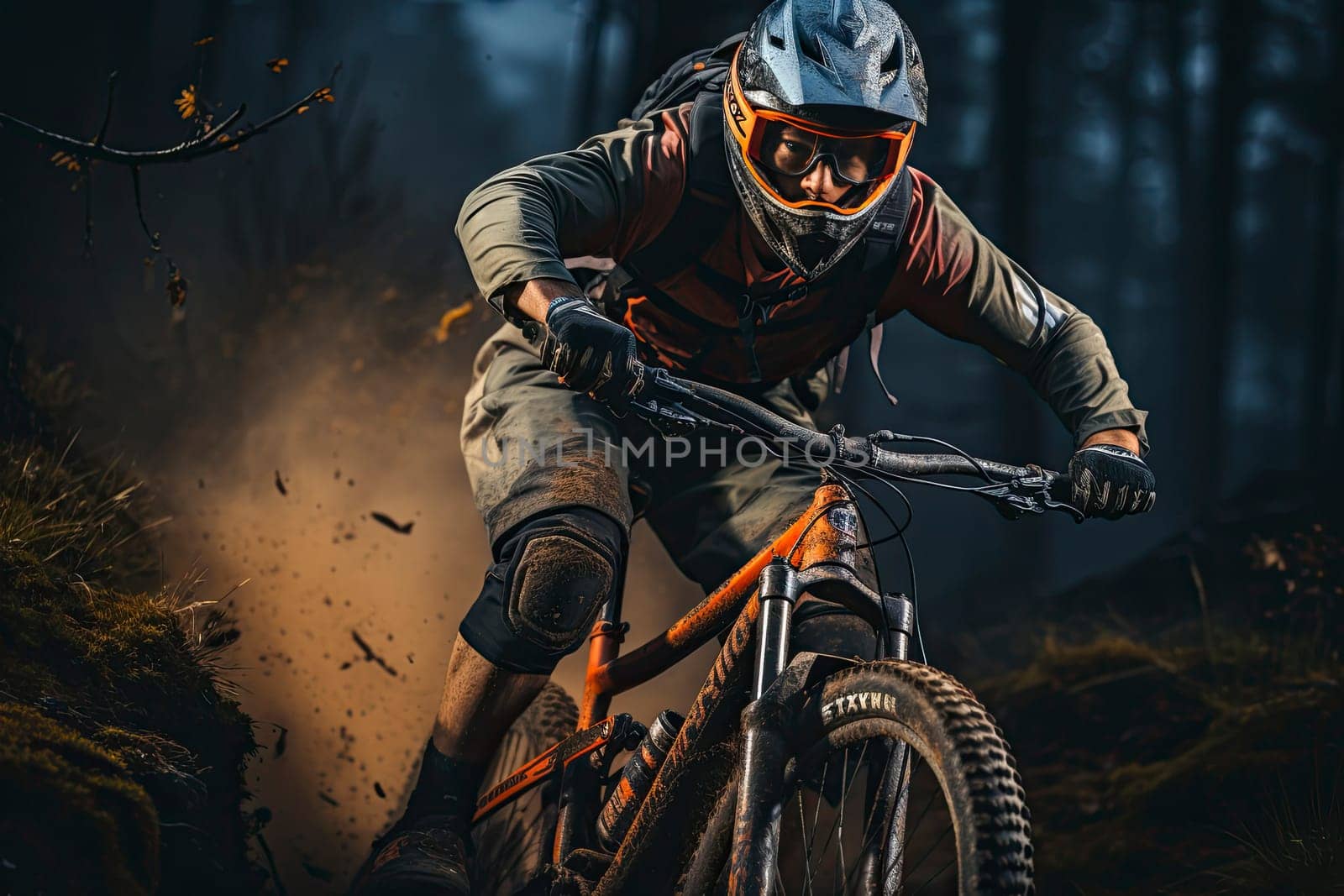 Professional Cyclist Riding the Downhill Mountain Bike on the Summer Rocky Trail at the Evening. Extreme Sport and Enduro Cycling Concept.