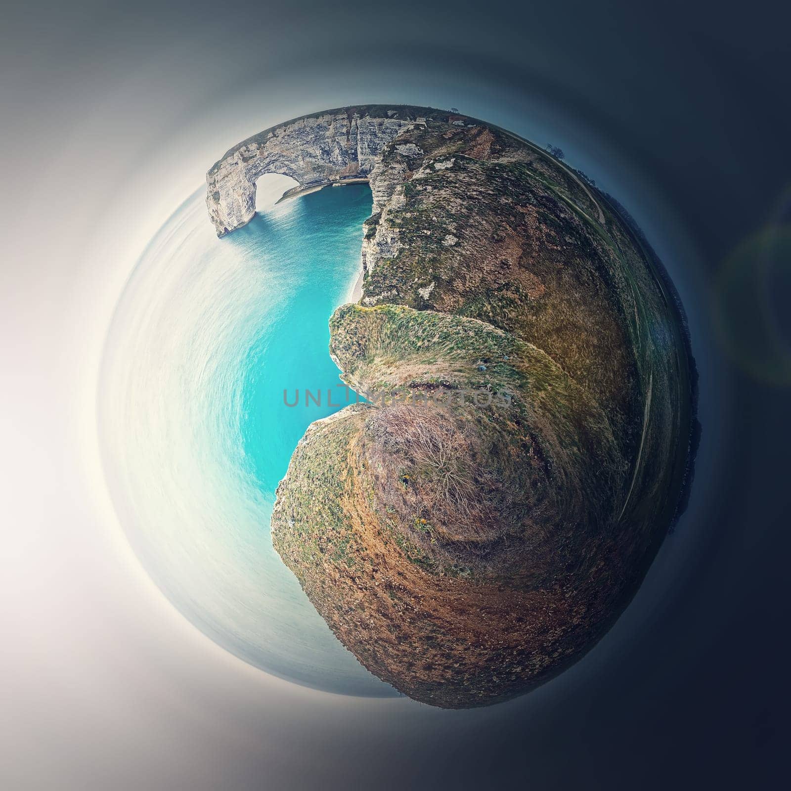 Sightseeing panoramic view to the Porte d'Aval arch cliff as a micro planet in space. Ocean waters continental side of Etretat, Normandy, France. Beautiful coastline scenery of famous Falaise d'Aval