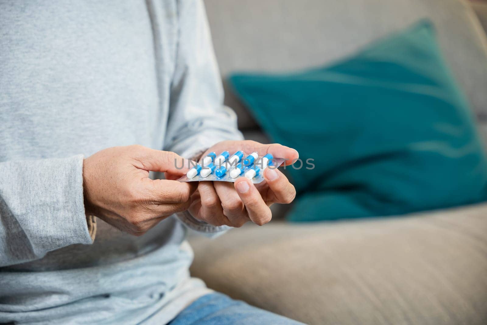 Asian worried senior man with medicine pills he read on see how to take pills before taking, old man buy herbal self cure Rx pill online from pharmacy, home isolation, Medical service concept