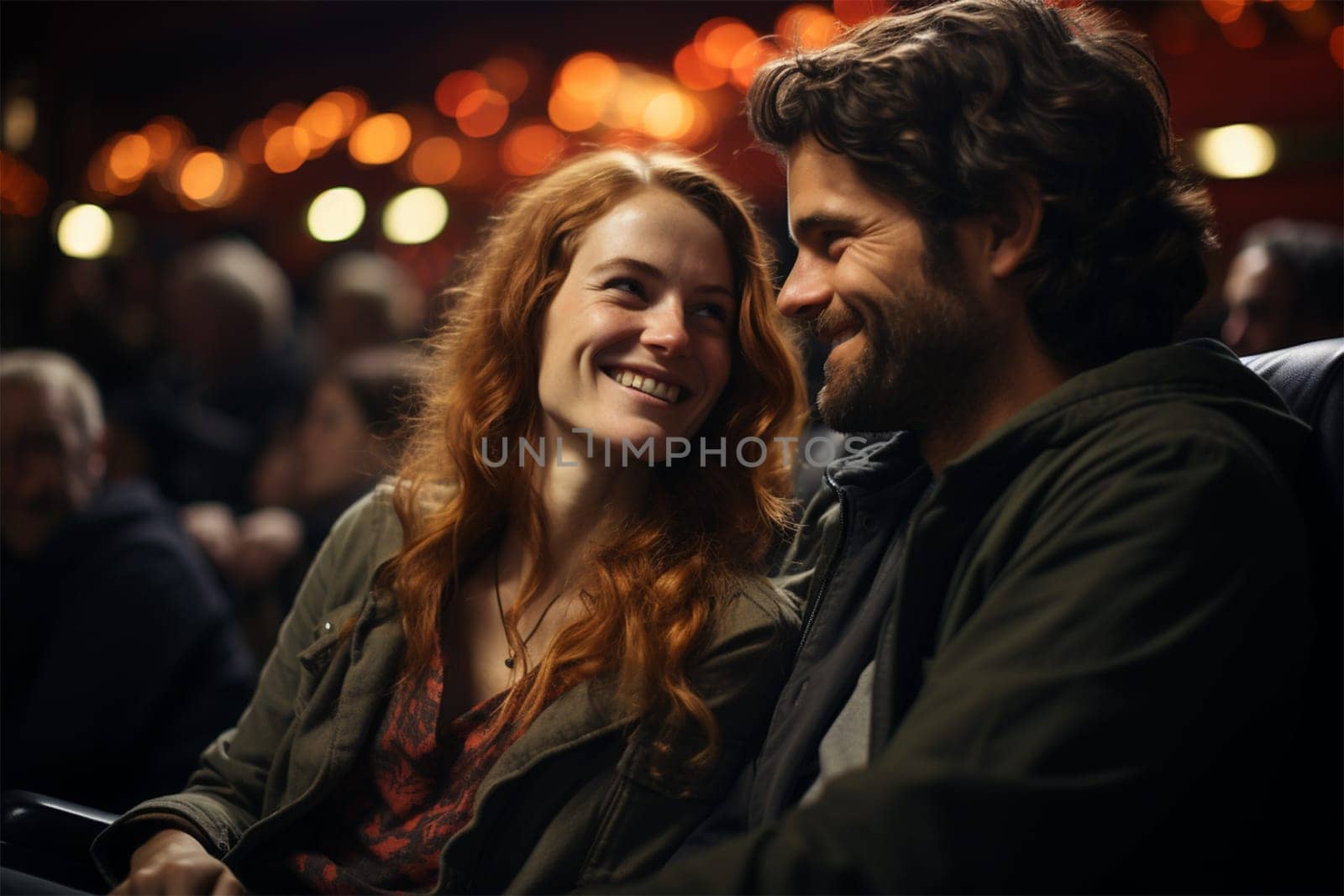 a couple in love in the cinema auditorium looking at each other.before a film show