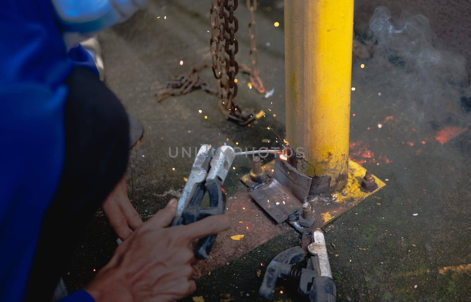 Industry worker welding steel structure at work background.