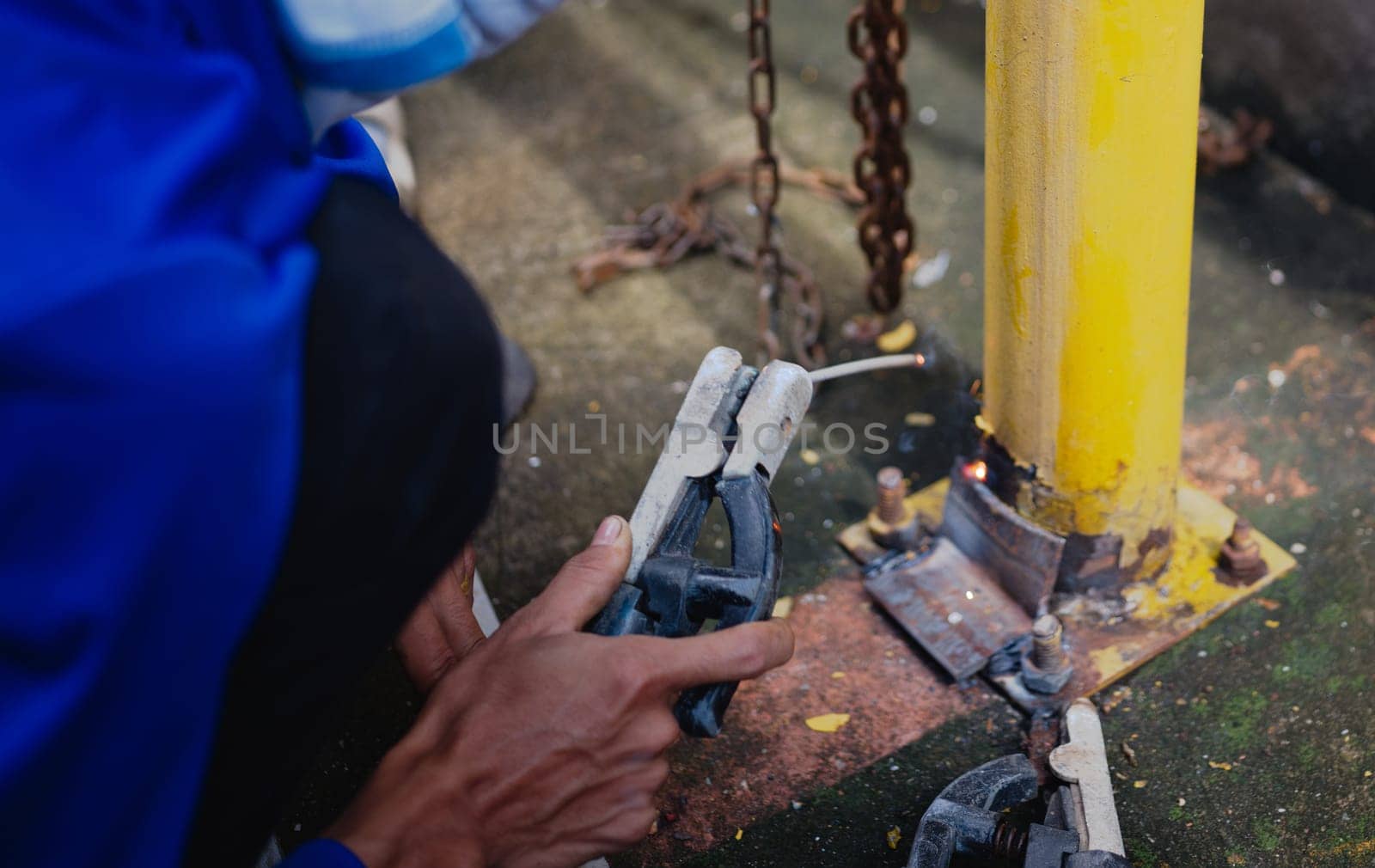 Industry worker welding steel structure at work background.