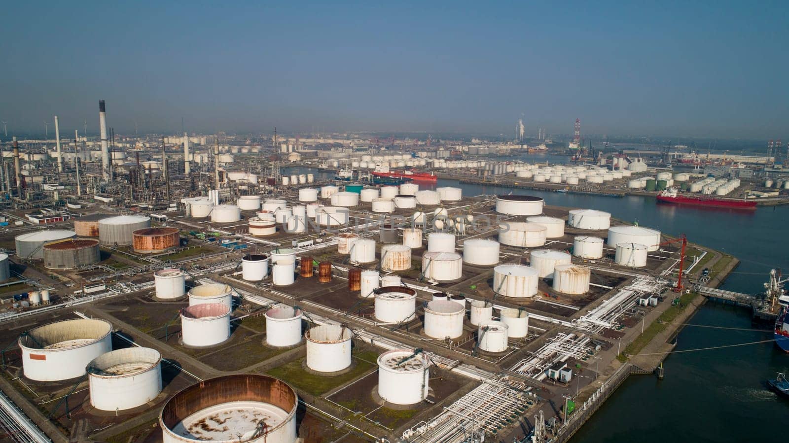 Oil refinery plant from industry zone, Aerial view oil and gas industrial, Refinery factory oil storage tank and pipeline steel