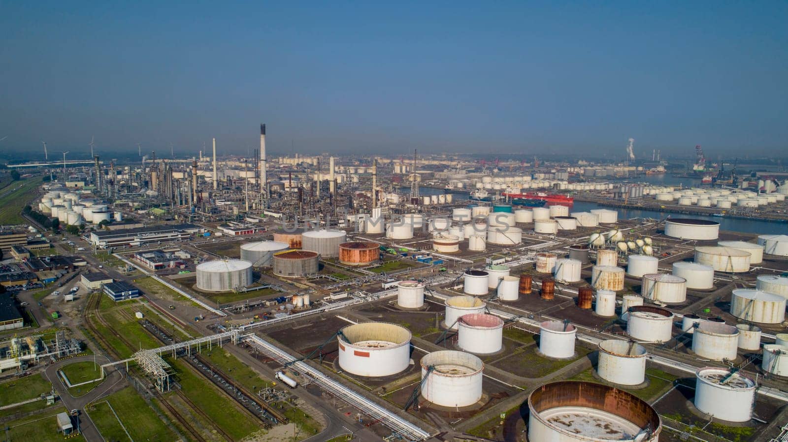Port of Rotterdam. Botlek. Oil refinery plant from industry zone, Aerial view oil and gas industrial, Refinery factory oil storage tank and pipeline steel