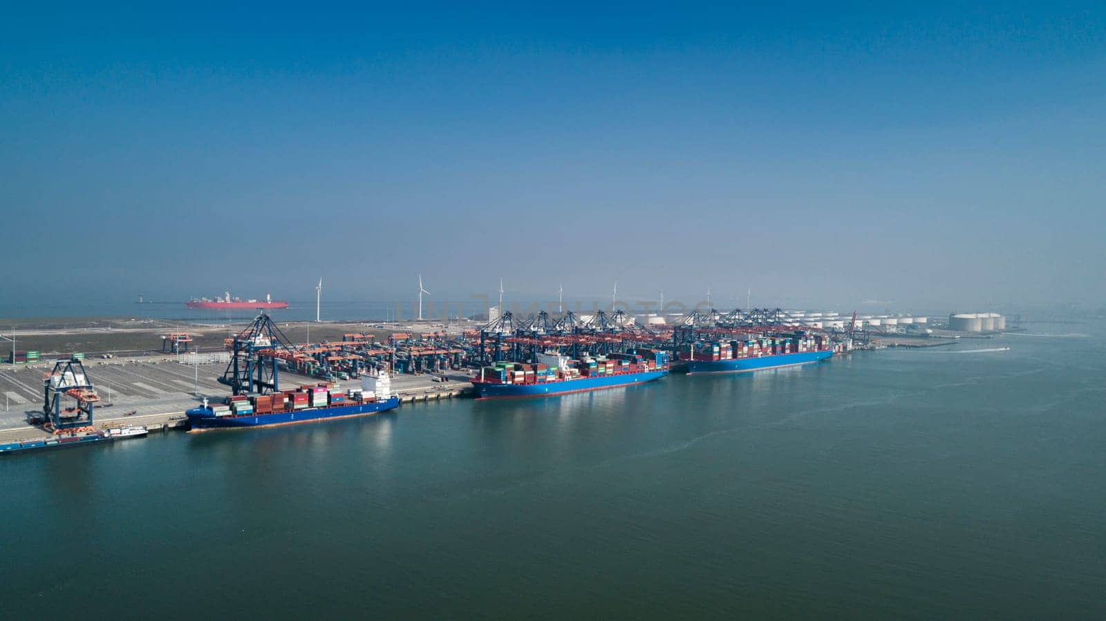 Aerial view of container terminal in the harbor MAASVLAKTE, Netherlands. A large containership from Cosco is unloading