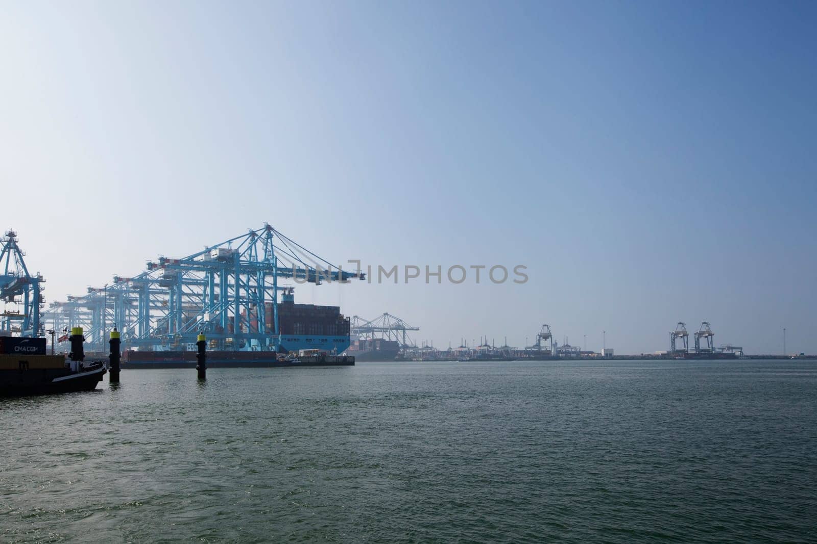 Rotterdam, Holland. Aerial view of container terminal in the harbor MAASVLAKTE, Netherlands. A large containership is unloading