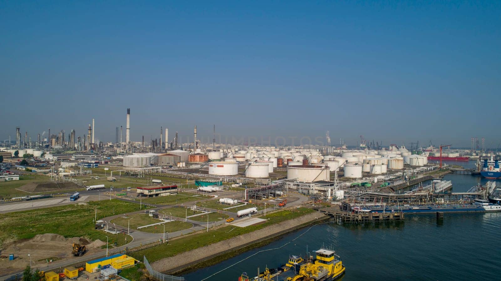 Oil refinery plant from industry zone, Aerial view oil and gas industrial, Refinery factory oil storage tank and pipeline steel