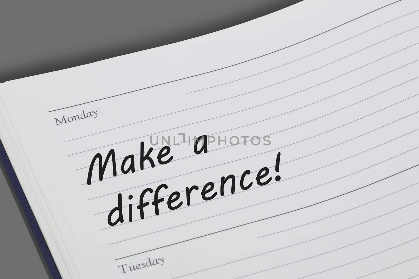 A Make a difference concept diary reminder open on a desk
