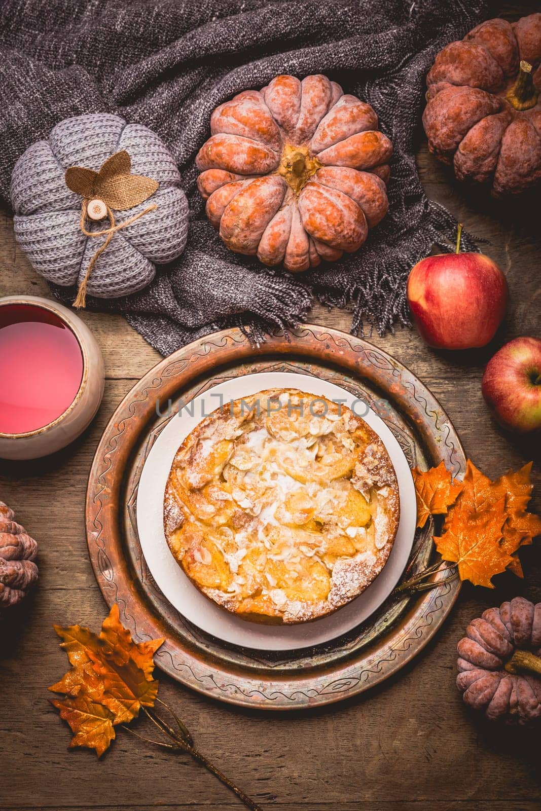 Apple pie with almonds and cup of herbal fruit tea for Thanksgiving.