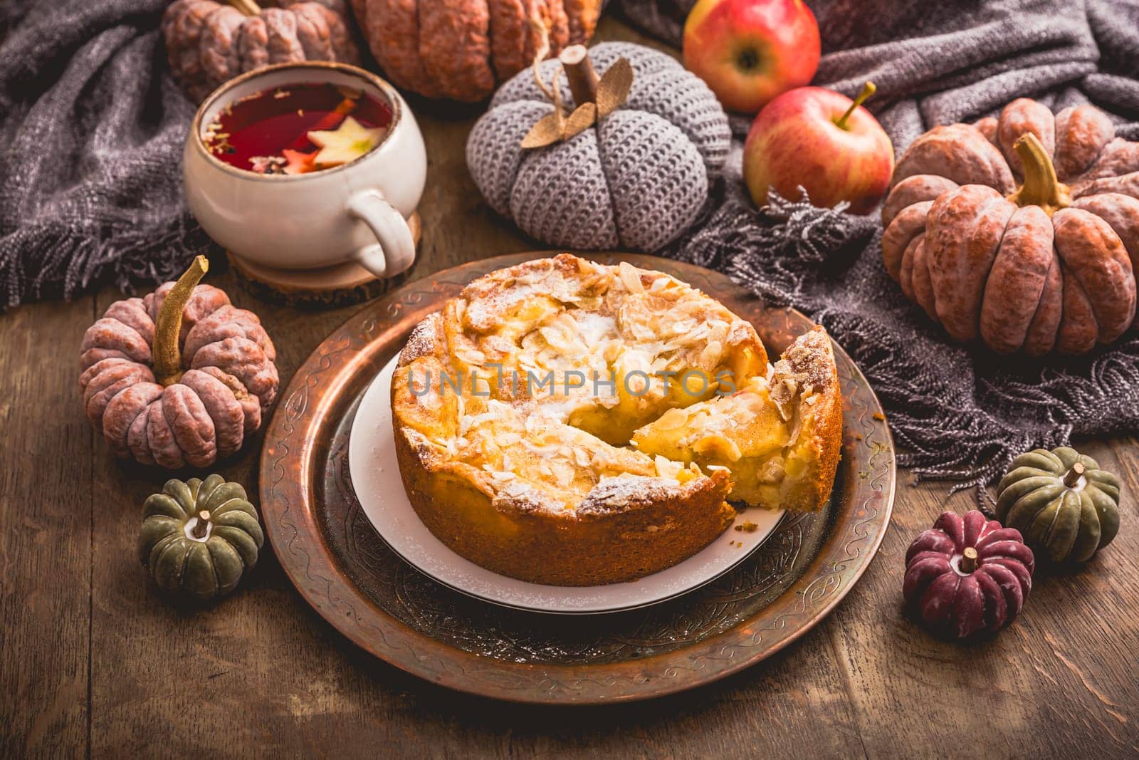 Apple pie with almonds and cup of herbal fruit tea for Thanksgiving.