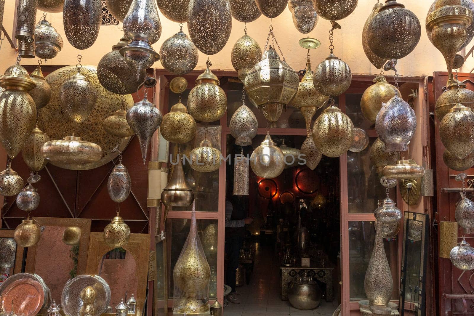 Entrance to a store in Marrakech decorated with traditional lamps in various forms and colors, Morocco