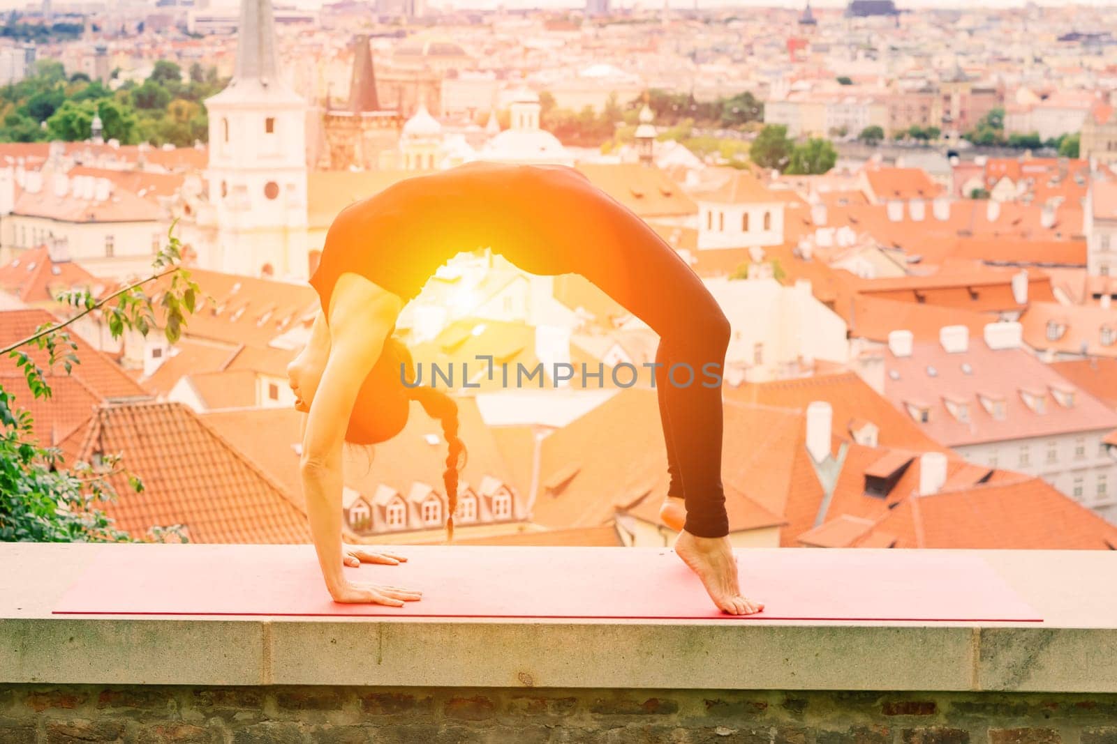 Healthy woman in a sportswear practicing yoga outdoor, doing exercise, full length portrait.