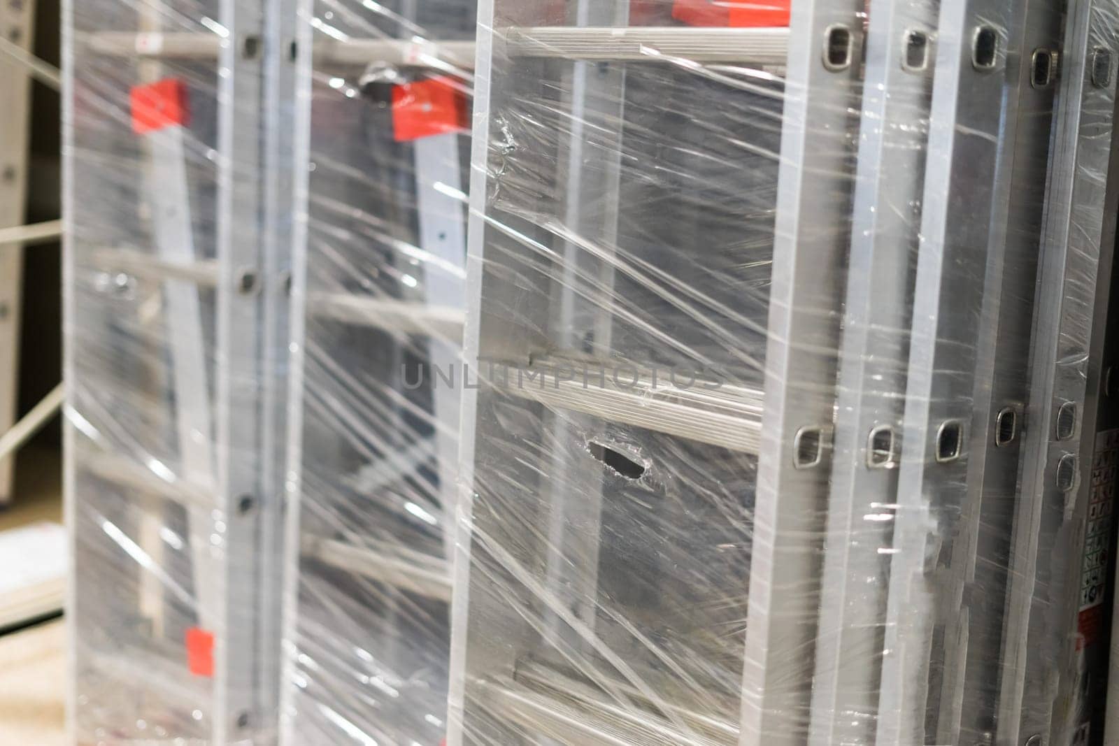 Aluminum extension ladders. Construction industry product shop. Metal staircase for workers.