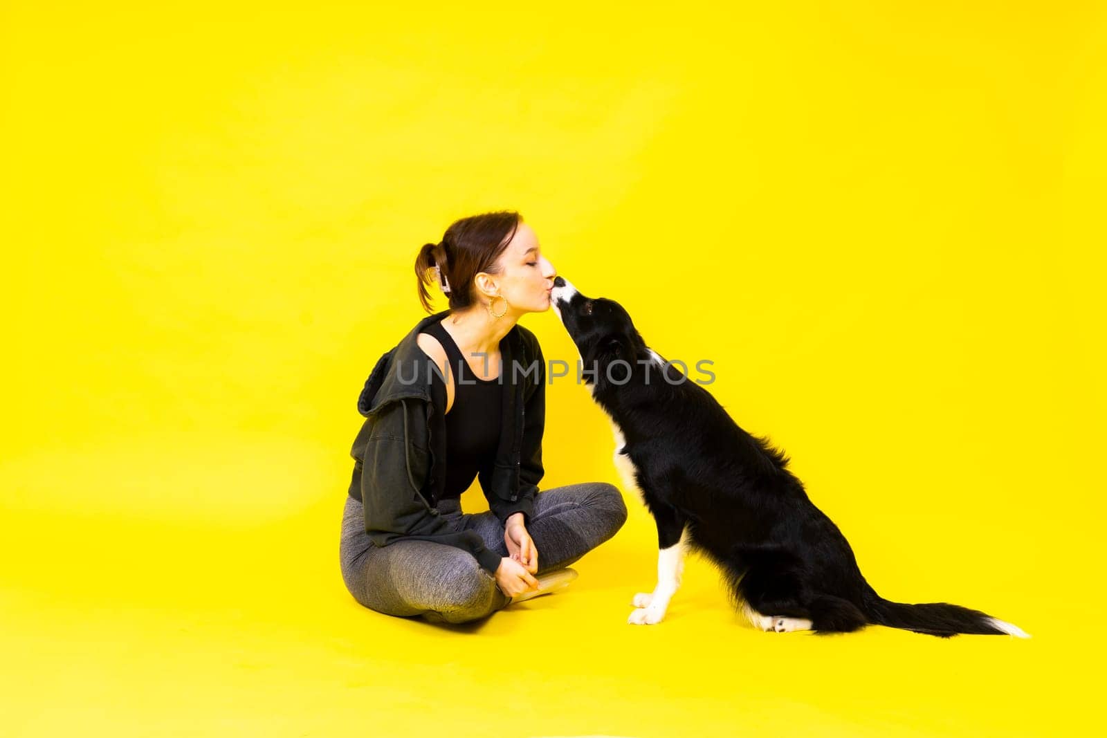 Friendship between people and animals, a studio shot, love, tender, warm feeling and emotion