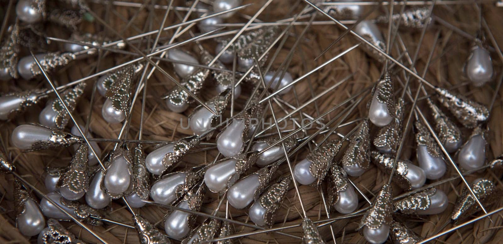 Basket full of pearl head pins. Overhead shot