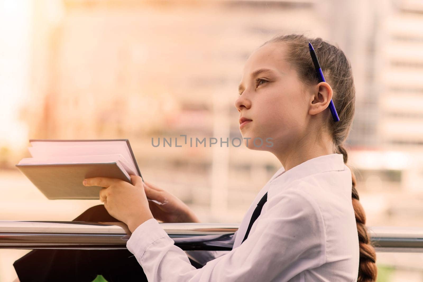 What is this book about. Literature lesson. Back to school. Modern education. Thinking little girl with notebook.