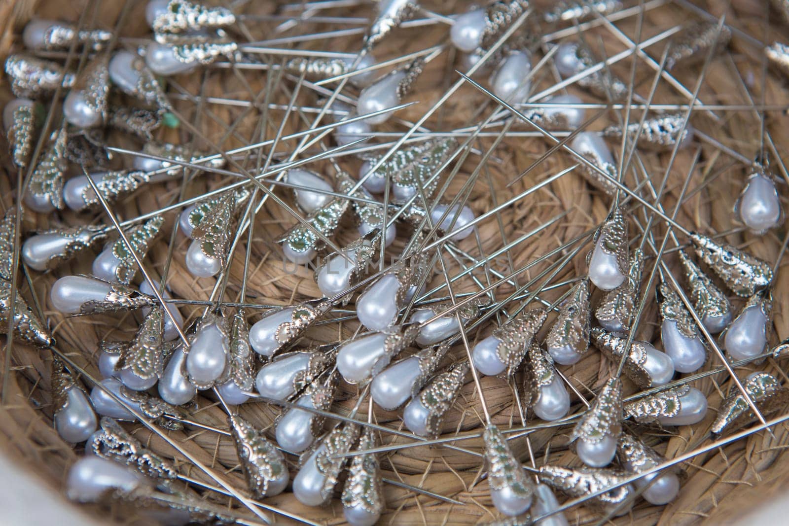 Basket full of pearl head pins. Overhead shot