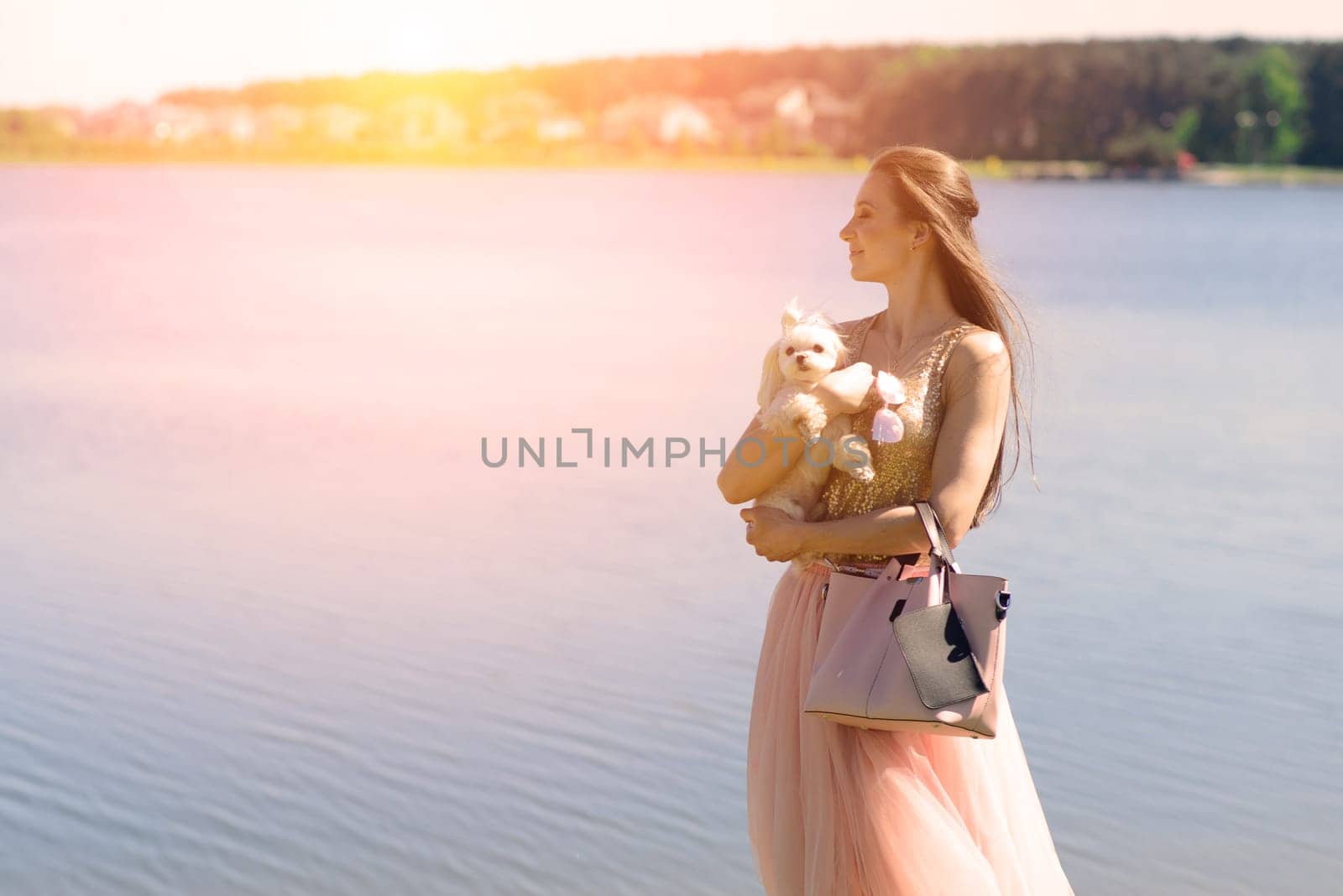 Young girl with her dog. Puppy white dog is running with it's owner. Conception about friendship, animal and freedom.