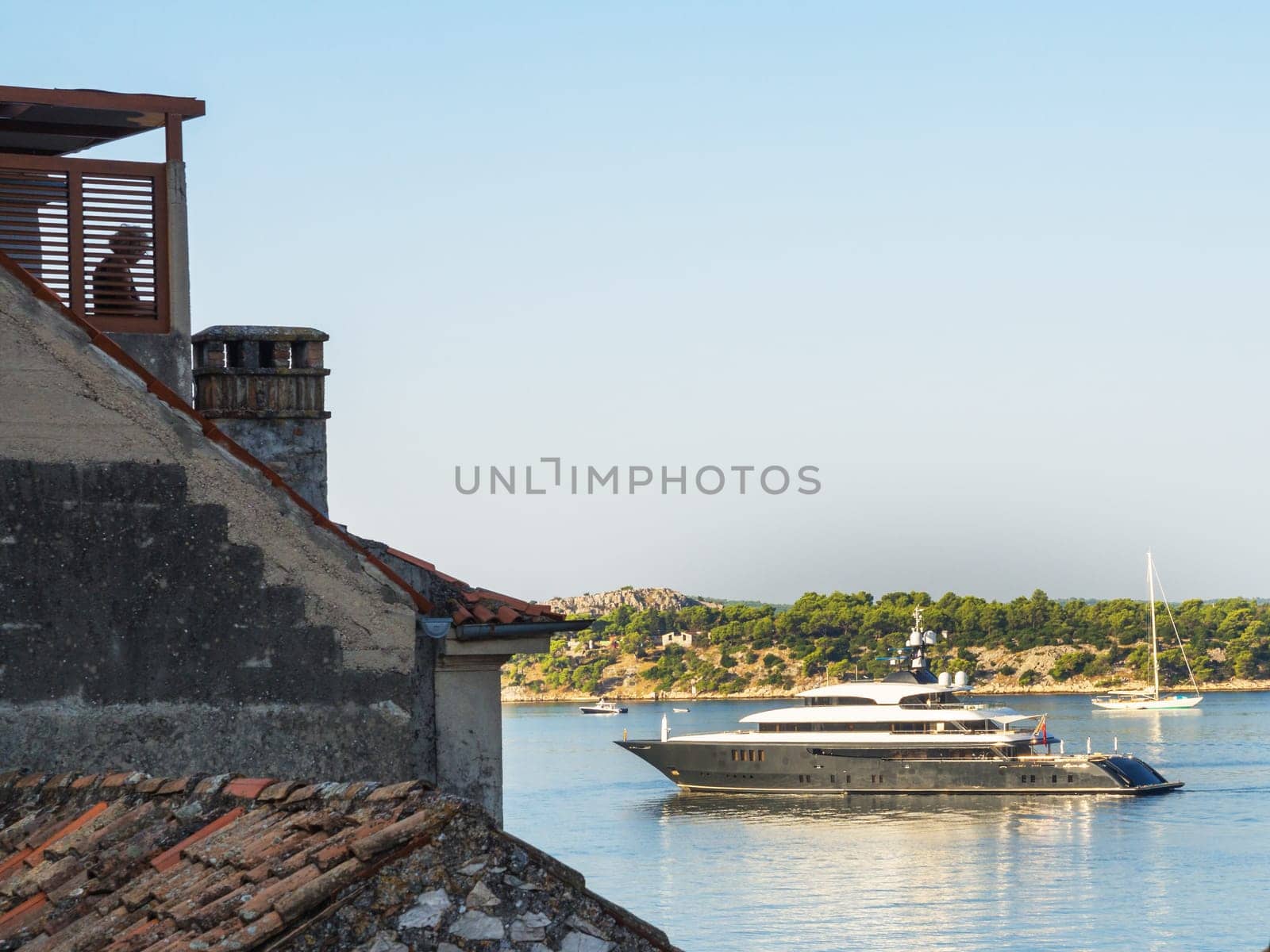 luxury yacht entering port of sibenik