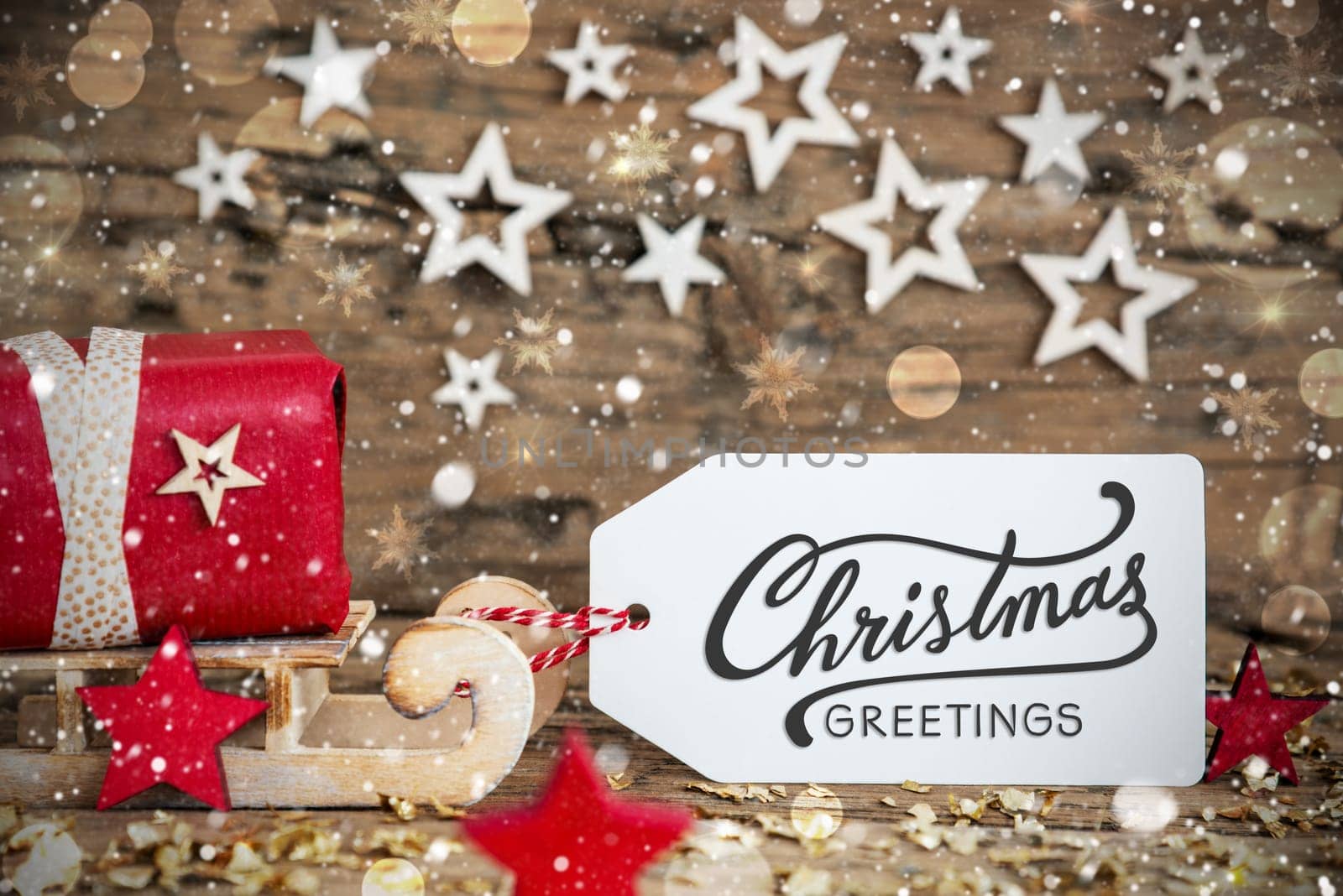 Wooden Sled With Red Gift And Rustic Snowy Christmas Background With Label With Text Christmas Greetings