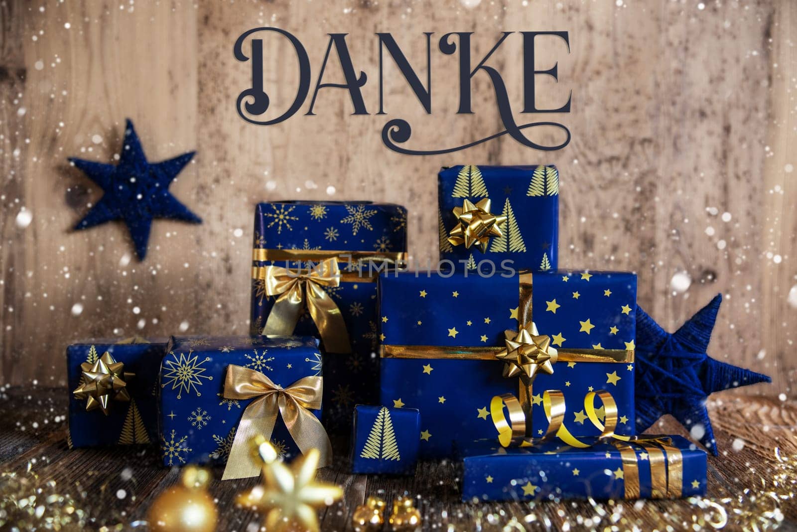 German Text Danke, Means Thanks In English, Wooden Background, Blue Christmas Presents, Snowfall, Gifts And Winter Decoration