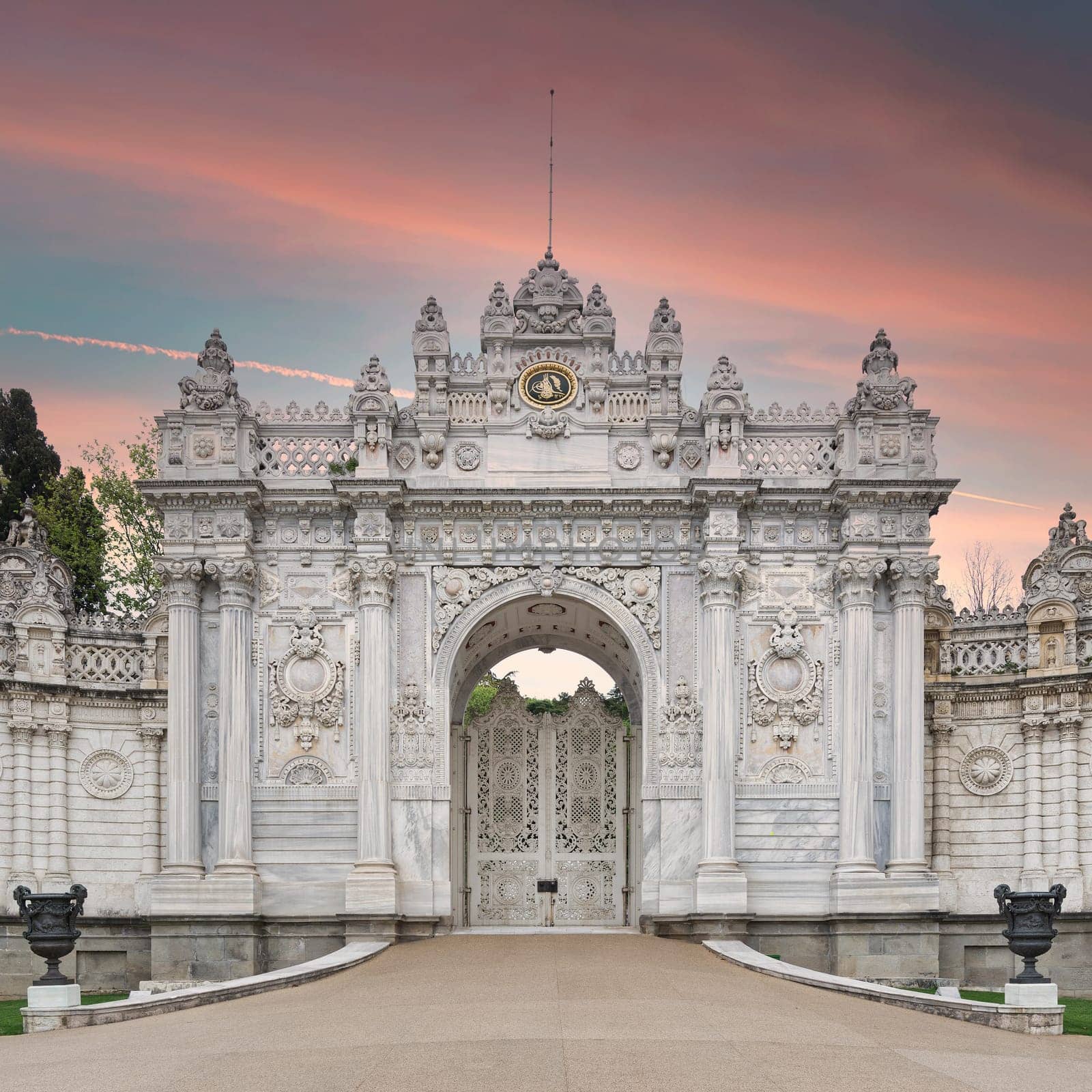 Dawn shot of closed gate leading to former Ottoman Dolmabahce Palace, or Dolmabahce Sarayi, suited in Ciragan Street, Besiktas district, Istanbul, Turkey. View from the internal court