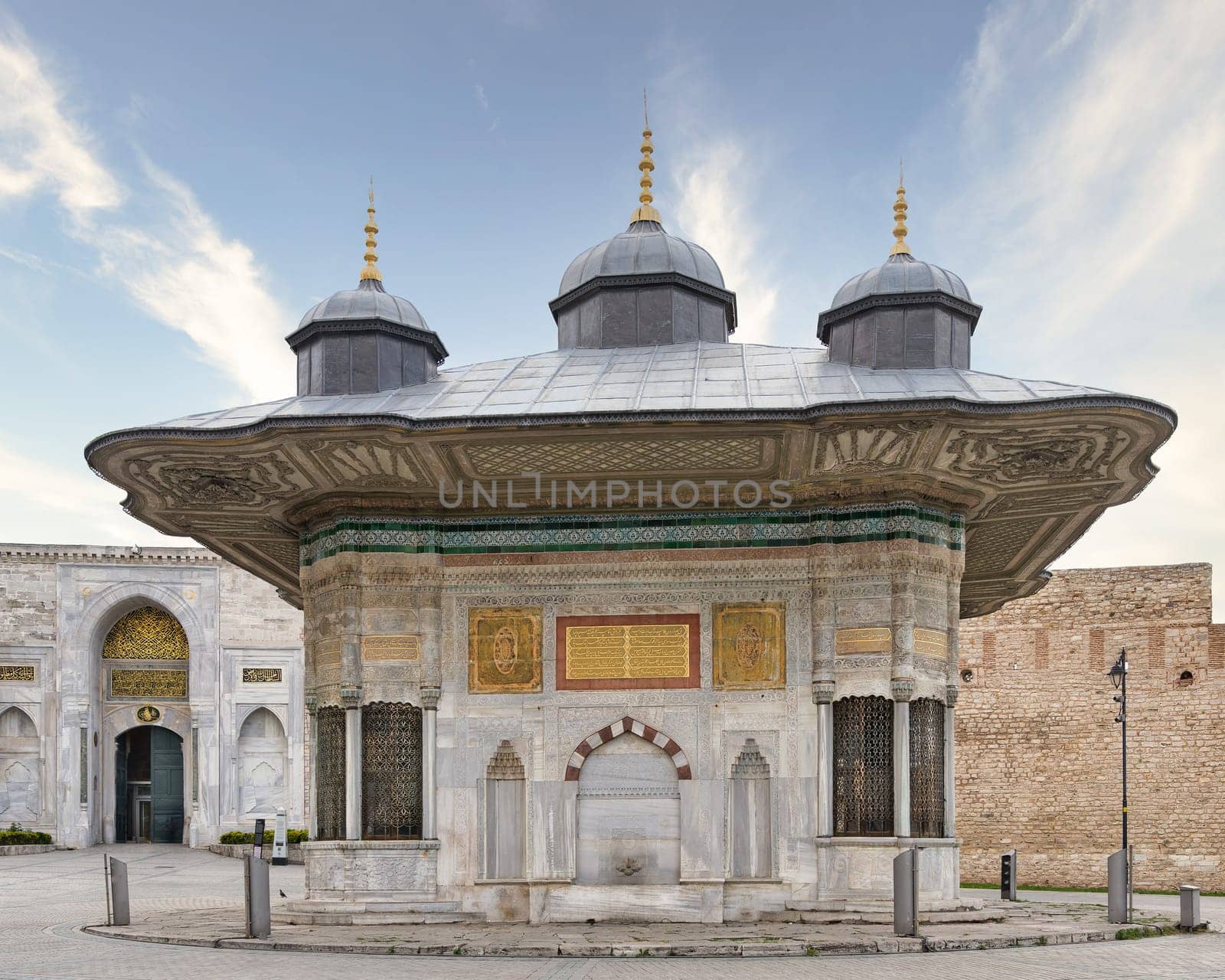 Fountain of Sultan Ahmed III, or Ahmet Cesmesi, a 17th century public Turkish rococo water fountain, or Sebil, located in the Great Square, beside the Imperial Gate of Topkapi Palace, Istanbul, Turkey