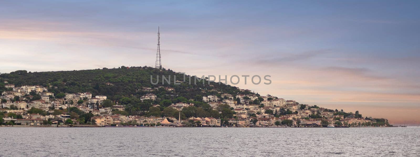 Breathtaking view of the island of Heybeliada with lush forests and traditional houses at sunrise, located in the Sea of Marmara just off the coast of Istanbul, Turkey