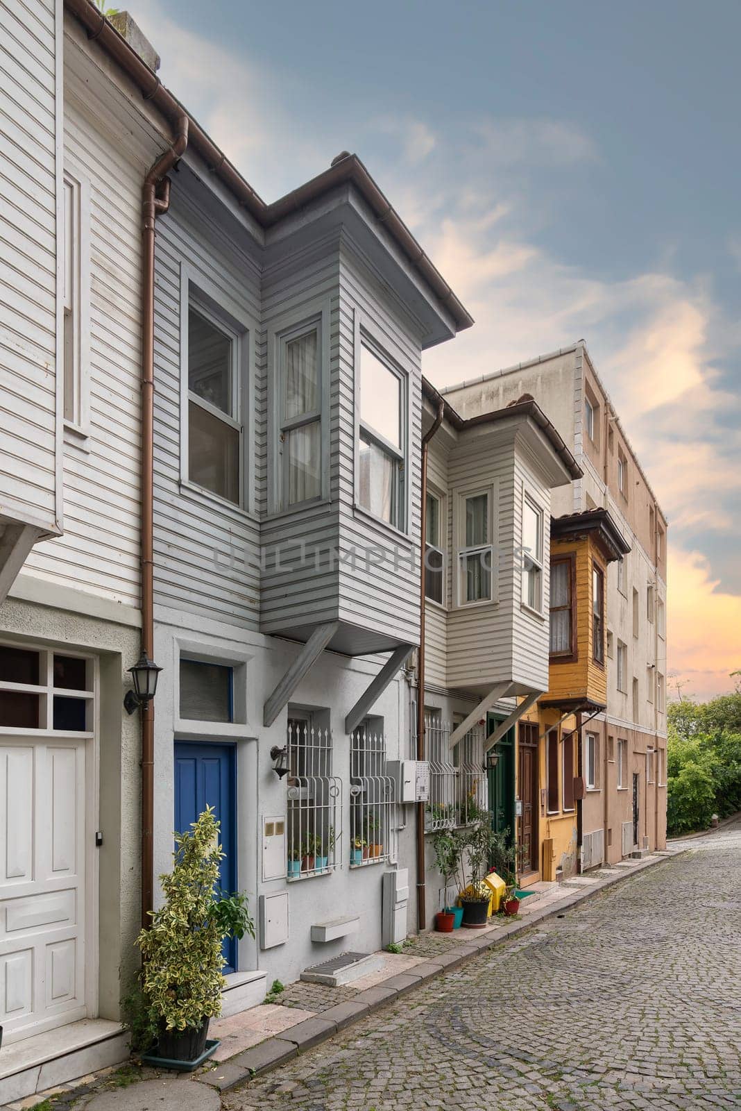 Narrow cobblestone alley with colorful wooden houses, suited in Kuzguncuk neighborhood, Uskudar district, Istanbul, Turkey