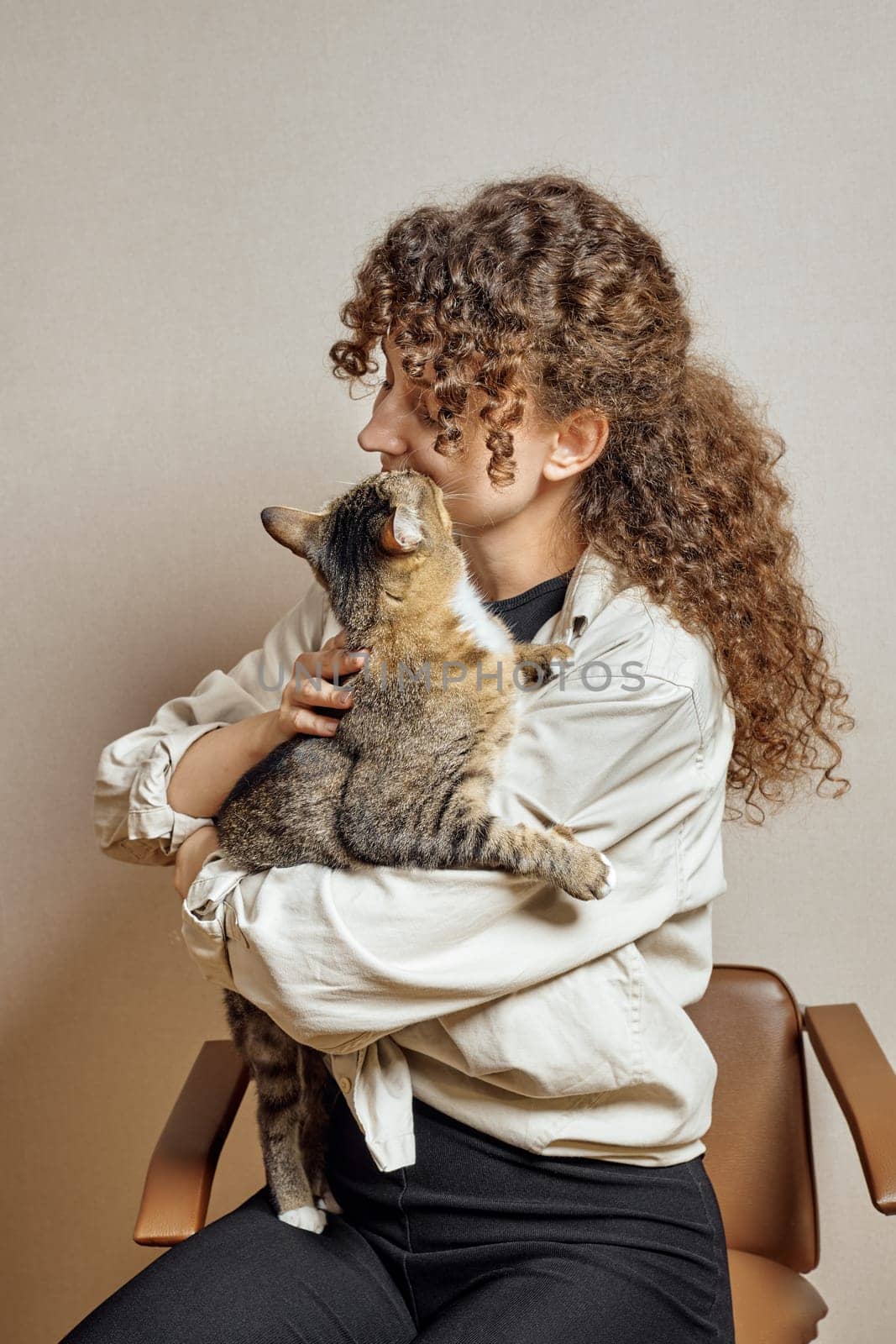 Tabby cat kisses his cute owner