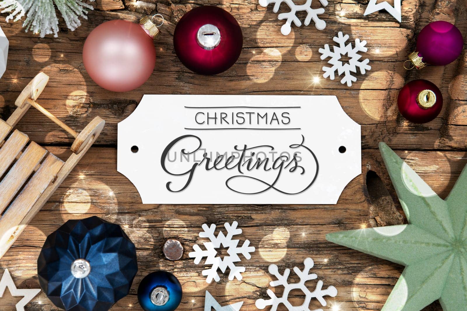 Colorful Christmas Decor With Bokeh, Christmas Balls And Snowflakes, With Sign With Text Christmas Greetings